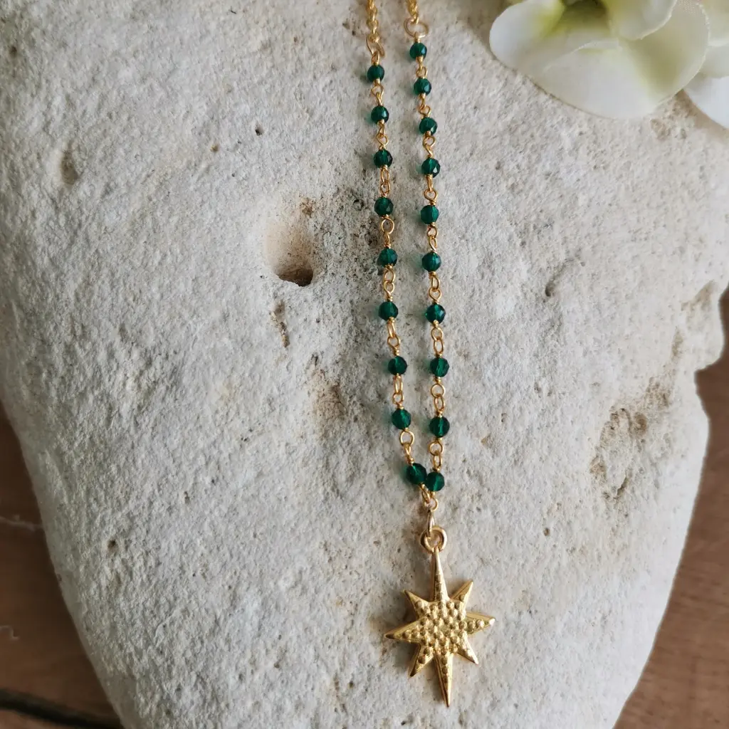 collier chaine rosaire en onyx vert avec une étoile dorée posée sur une pierre blanche